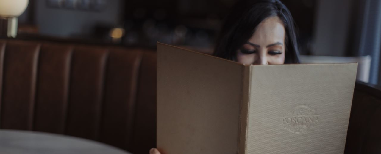 Woman reading a menu at a restaurant