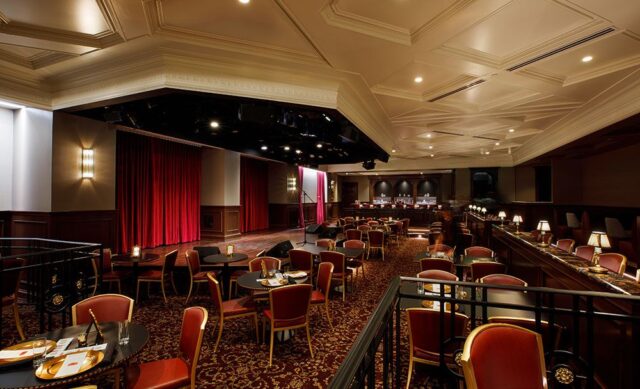 empty cabaret room with seating around raised stage