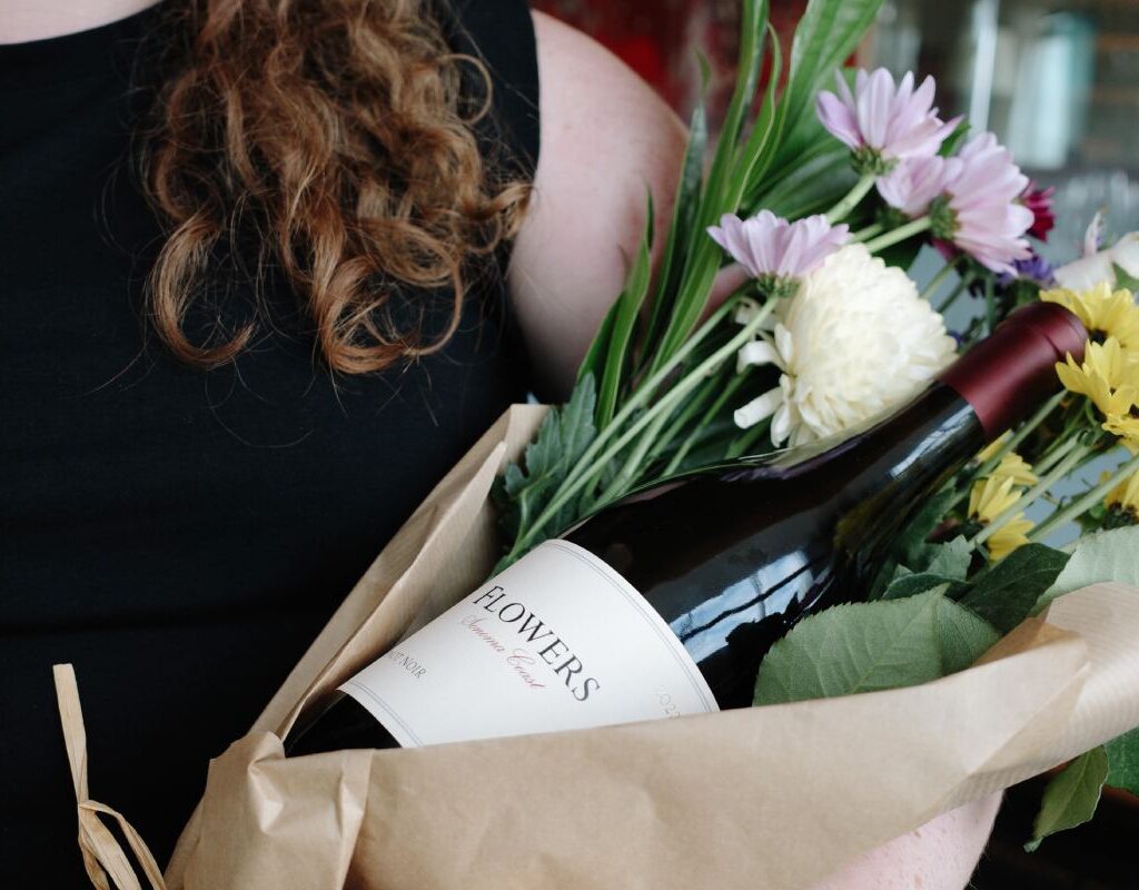 Women with flowers and wine bottle