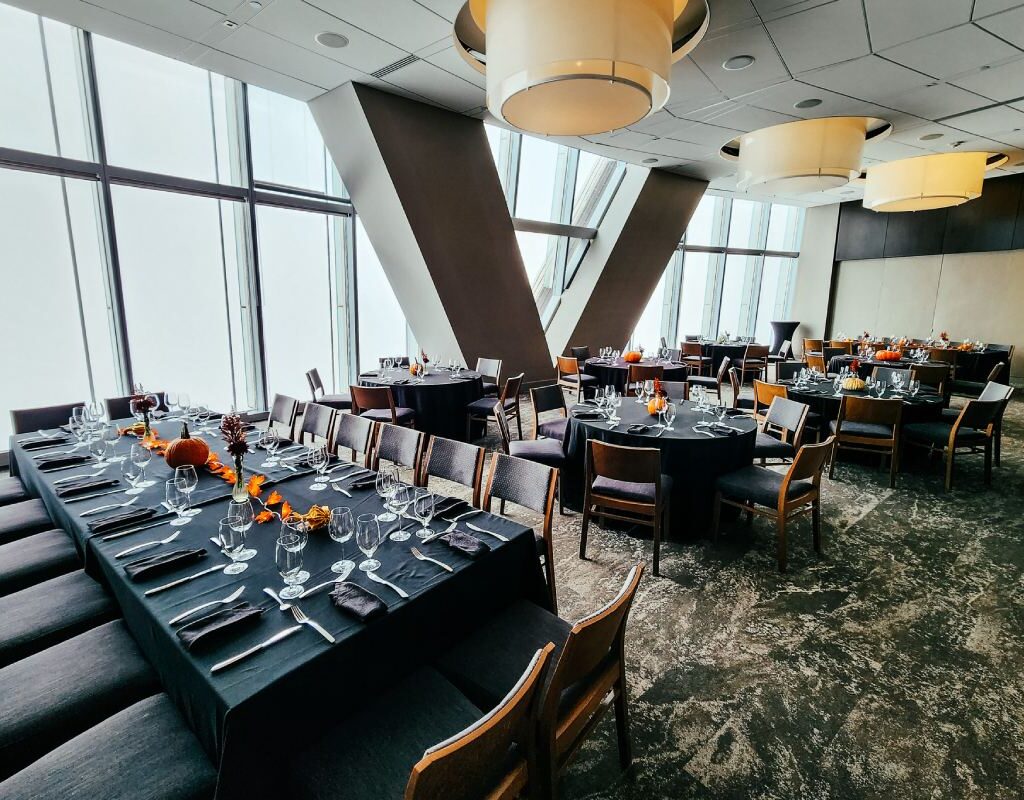 Big table and lot of chairs arranged at a hall