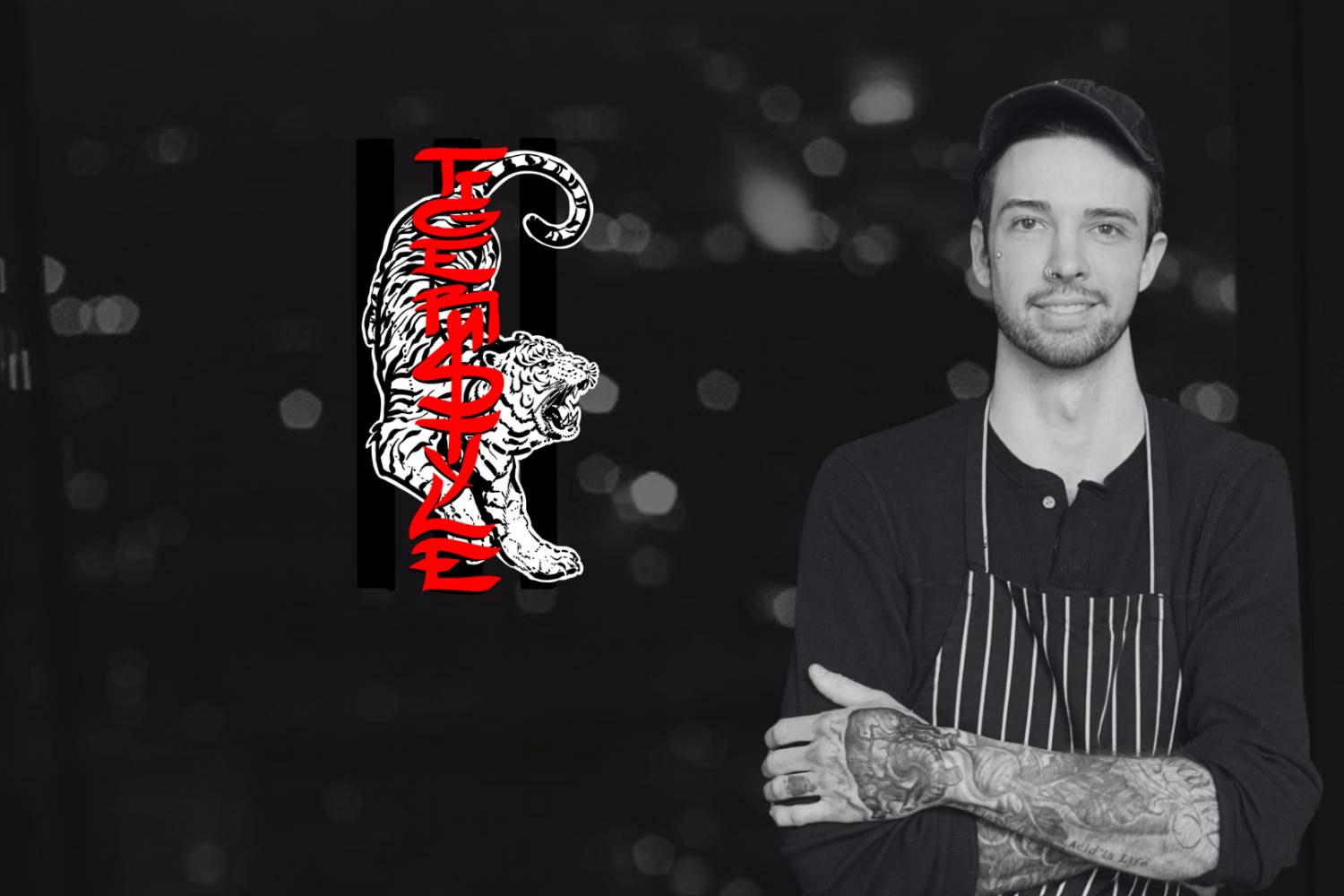 Chef in a striped apron posing next to a tiger graphic logo.